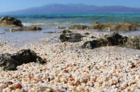 The sand beaches laid with small shells constitute one of its extraordinary features.